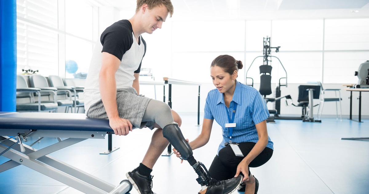 Person with an amputated limb working with a physical therapist