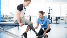 Person with an amputated limb working with a physical therapist