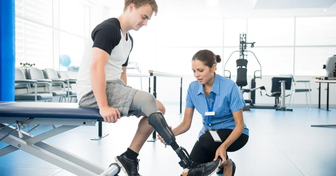 Person with an amputated limb working with a physical therapist